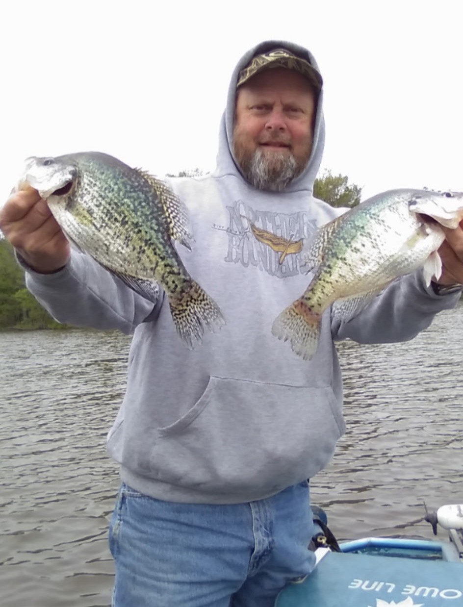 Man holding crappie on a guided Rend Lake fishing trip