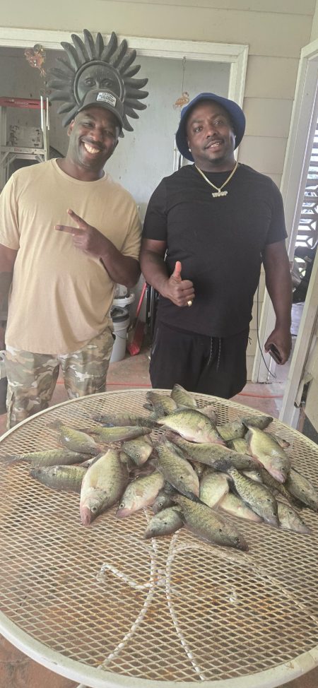 Two customers display their crappie catch after a guided fishing trip