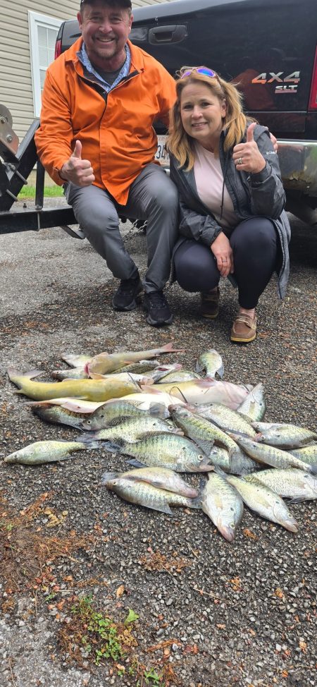 Husband & wife with a large catch of fish after a guided fishing trip on R end Lake