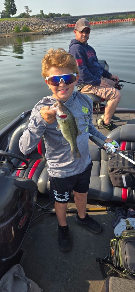 Father and son enjoying a guided fishing trip on Rend Lake with a bass
