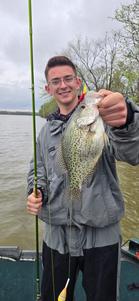 Teen angler holding a large crappie while fishing on Rend Lake with the guide