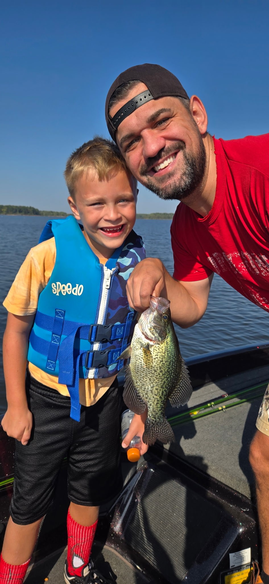 Father and son holding a crappie on a guided crappie fishing trip on Rend Lake